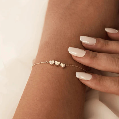 Rose gold heart initial bracelet close-up — engraved monogram for Valentine's Day gift