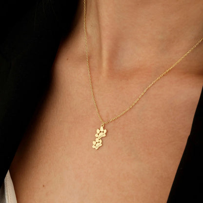 Rose gold paw necklace with multiple pet names — multi-pet household personalized keepsake