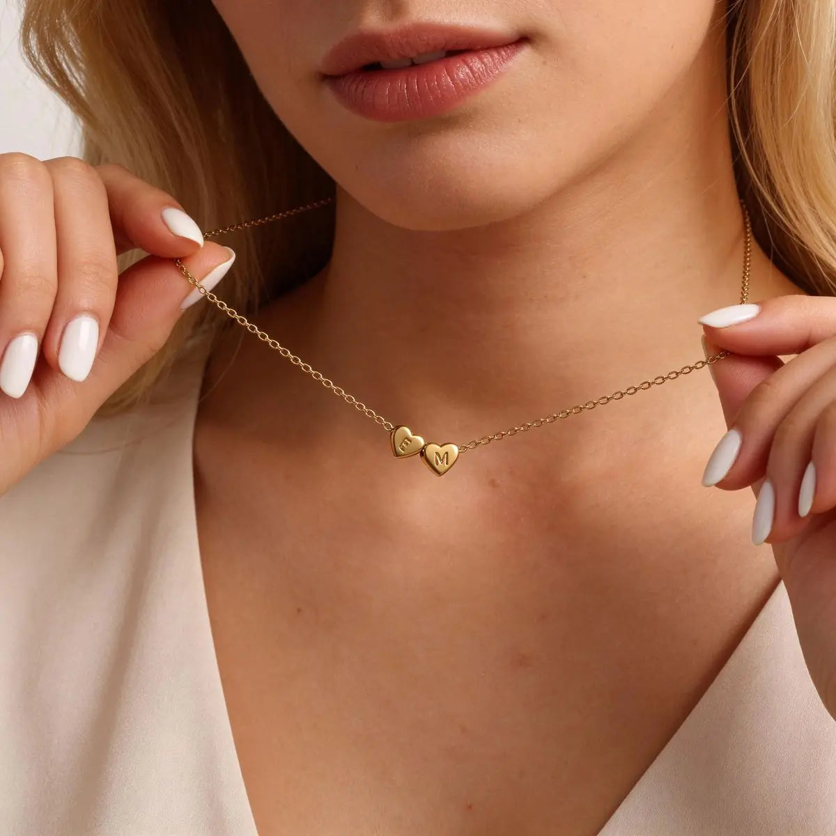 Heart initial necklace styled on woman's neck — handmade dainty everyday jewelry