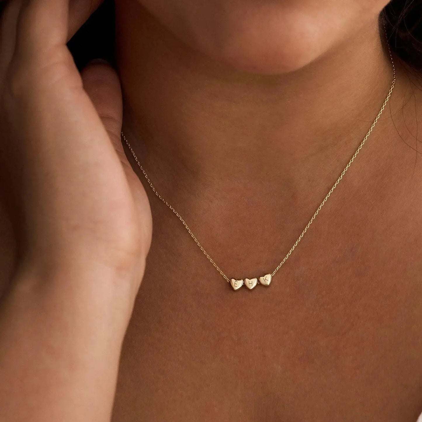Sterling silver heart initial necklace close-up — minimalist romantic personalized jewelry