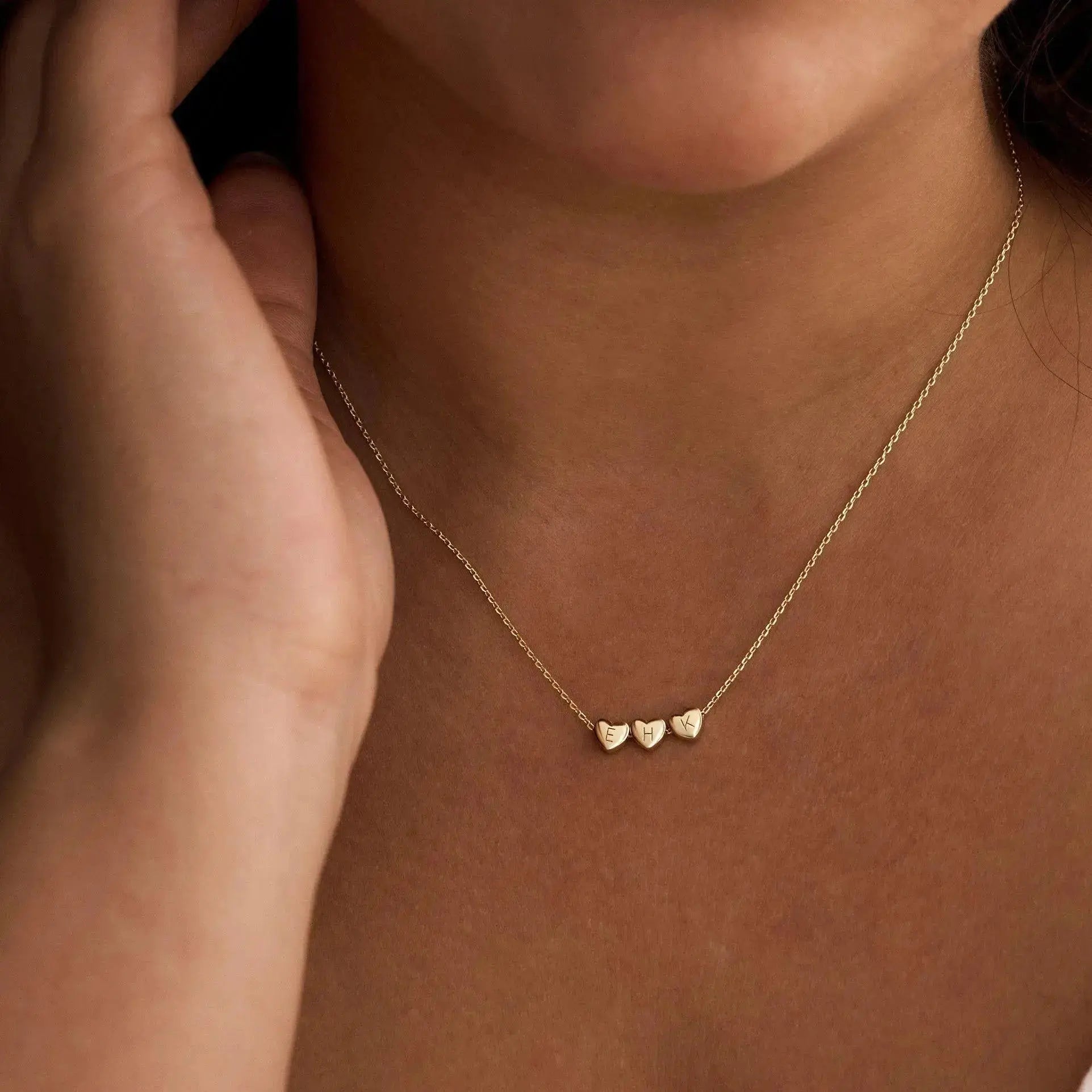 Sterling silver heart initial necklace close-up — minimalist romantic personalized jewelry