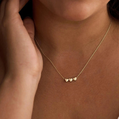 Sterling silver heart initial necklace close-up — minimalist romantic personalized jewelry