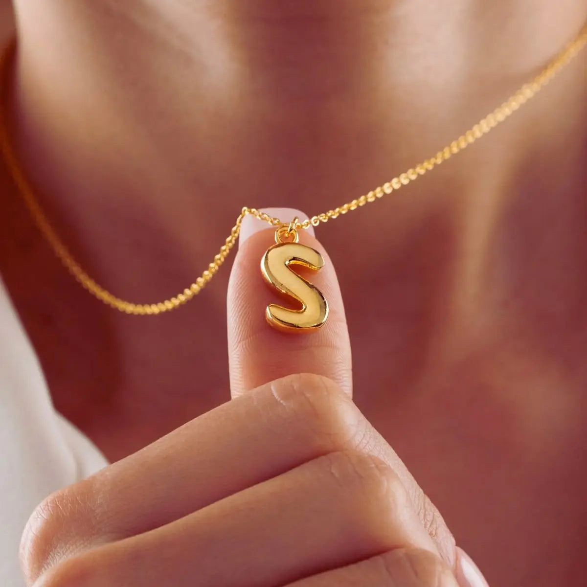 Y2K bubble letter necklace styled on neck — bold personalized everyday jewelry