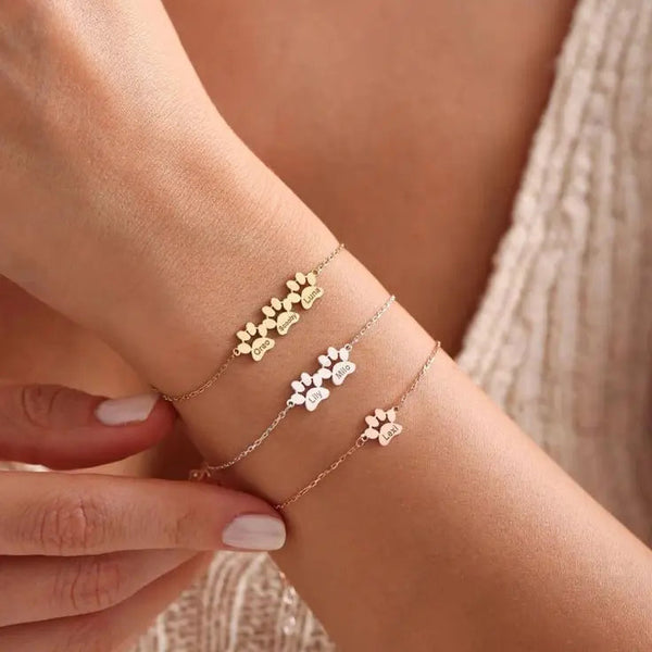 Personalized paw and pet name bracelet in gold-plated stainless steel on woman's wrist