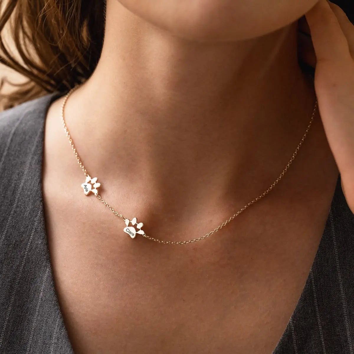Multi-pet paw necklace with separate charms — one paw and name per pet for multi-pet households