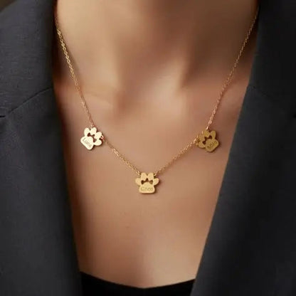 Multi-pet paw necklace charm engraving close-up — personalized stainless steel pet jewelry