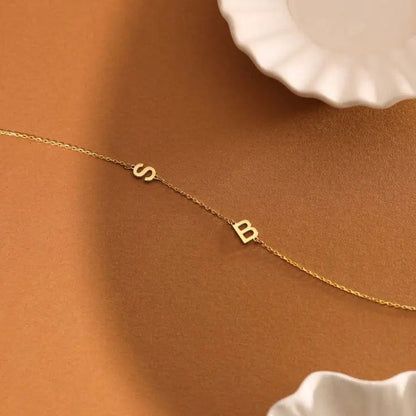 Sideways initial bracelet styled on woman's wrist — minimalist gift for sister or best friend