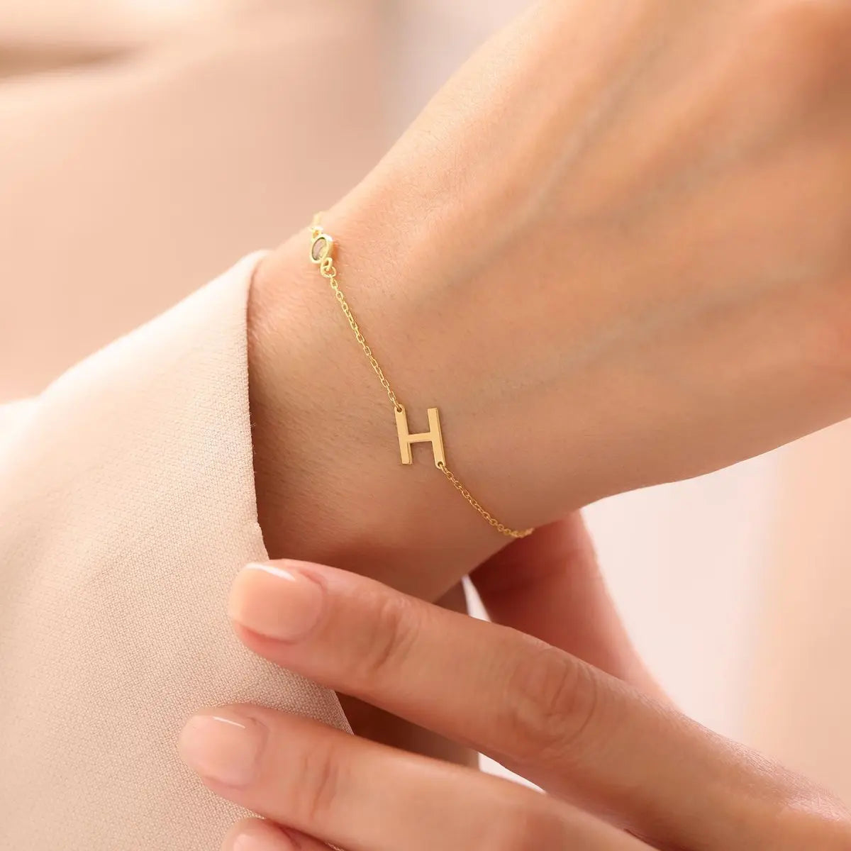 Sterling silver sideways initial bracelet detail — waterproof tarnish-resistant jewelry