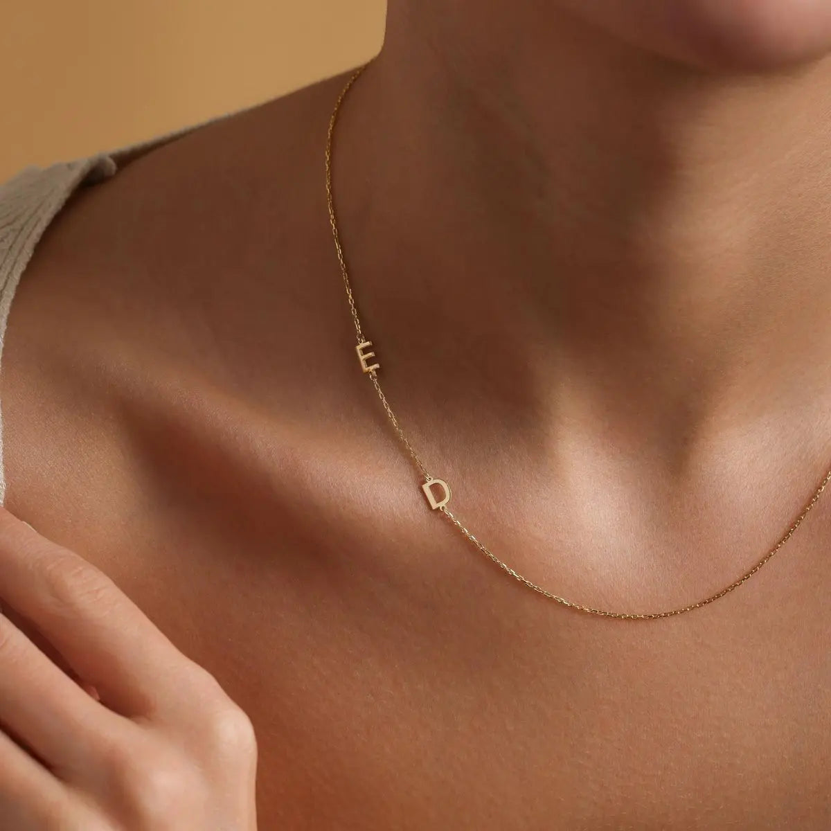 Sideways initial necklace styled on woman's neck — everyday minimalist jewelry for self or gift