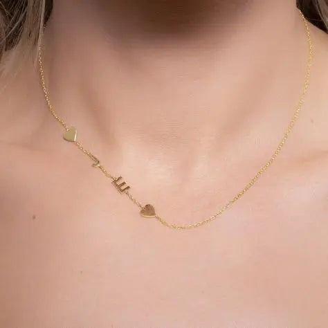 Sideways letter pendant photographed with flowers — romantic personalized jewelry gift