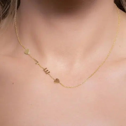 Sideways letter pendant photographed with flowers — romantic personalized jewelry gift