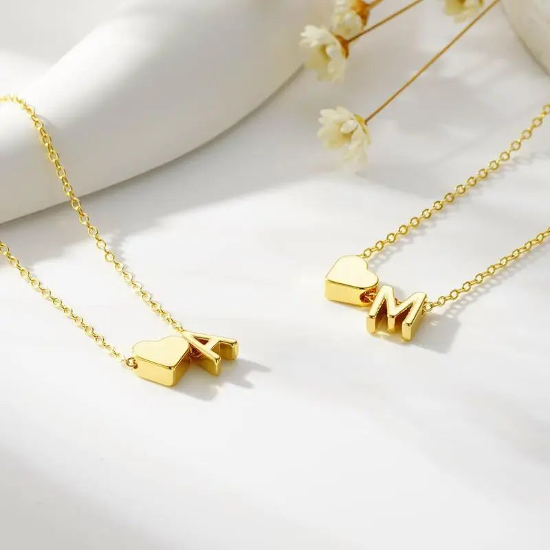 Heart pendant bracelet in gold close-up — engraved letter waterproof personalized keepsake
