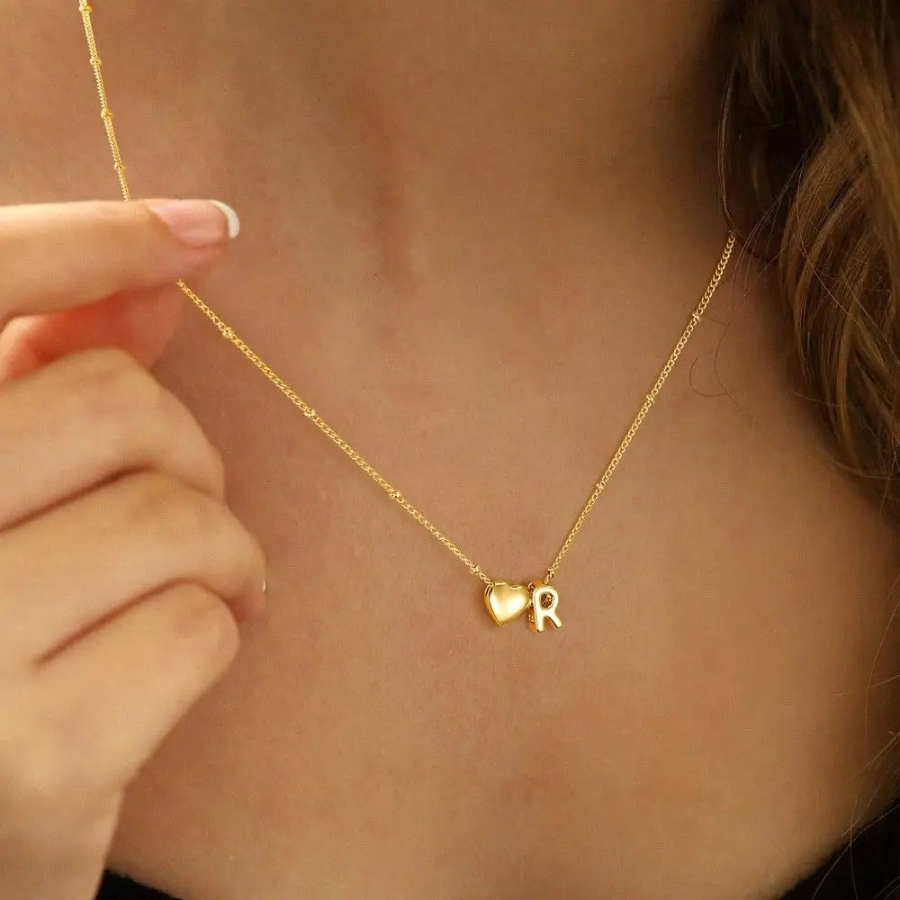 Heart initial necklace styled on neck — dainty romantic gift for girlfriend or wife