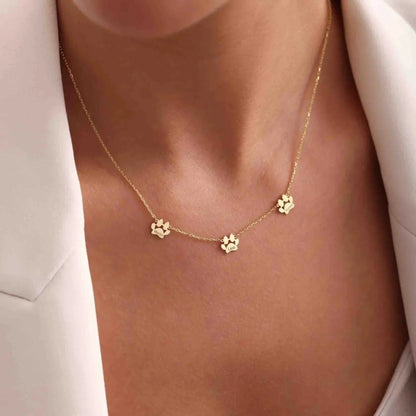 Multi-pet paw necklace detail shot — separate engraved charms for personalized pet jewelry