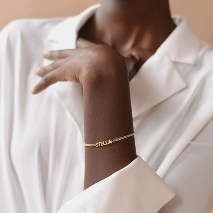 Personalized name bracelet in gold close-up — handmade dainty stainless steel jewelry