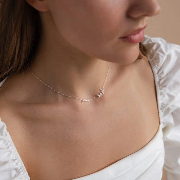 Woman wearing dainty multiple name necklace in cursive script — minimalist everyday personalized jewelry