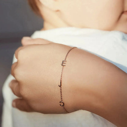 Sideways initial bracelet with engraving close-up — hypoallergenic stainless steel personalization