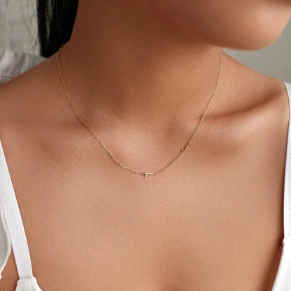 Sideways initial necklace in rose gold on minimalist outfit — Mother's Day or birthday gift