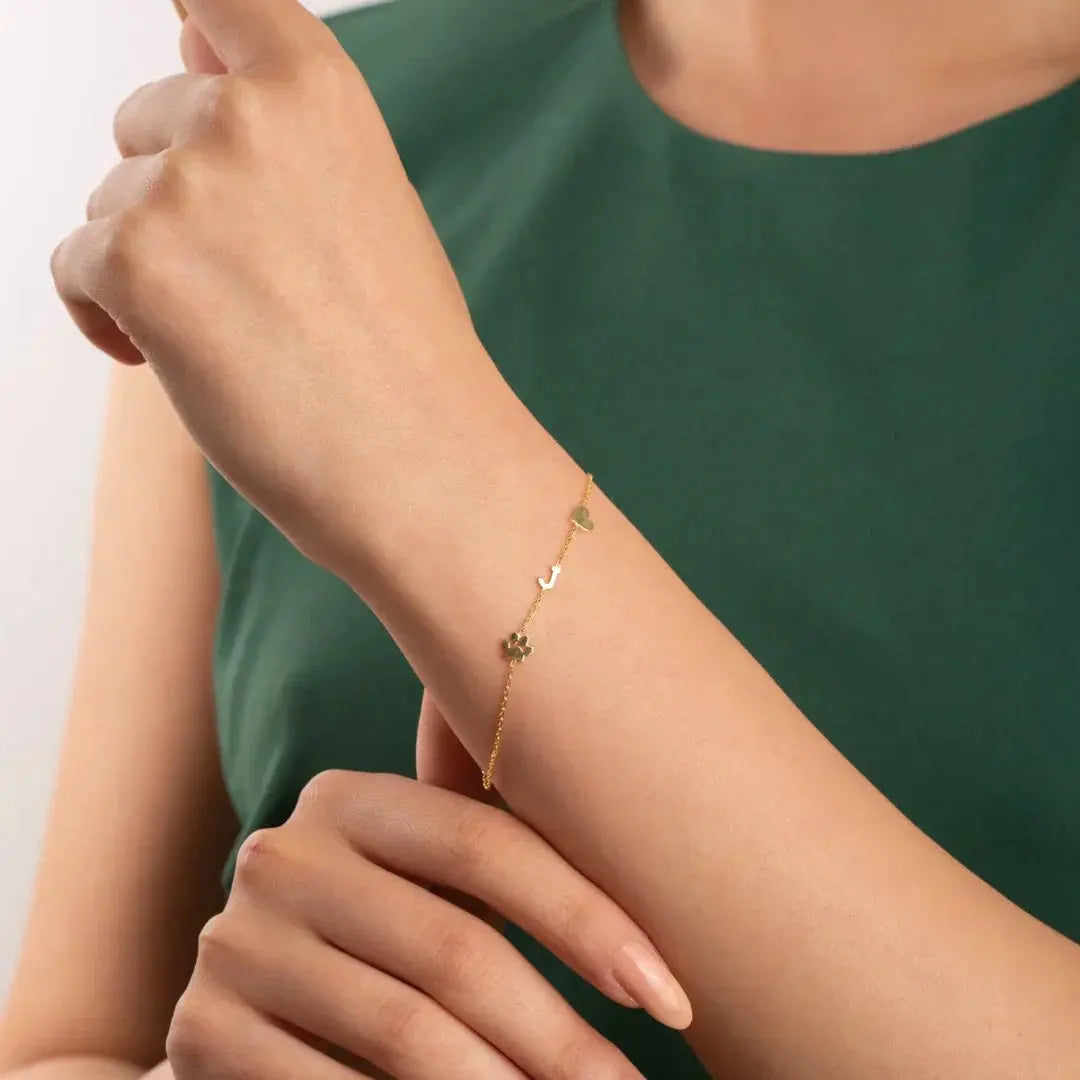 Sideways initial bracelet in sterling silver close-up — dainty everyday accessory
